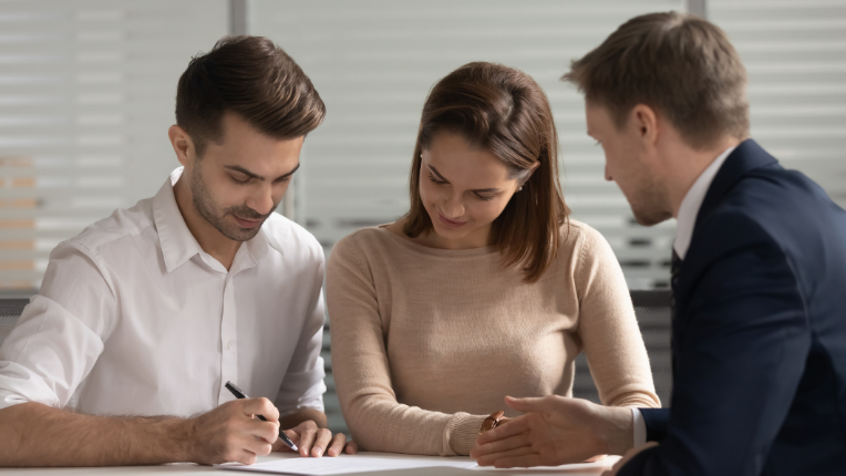 people signing a document