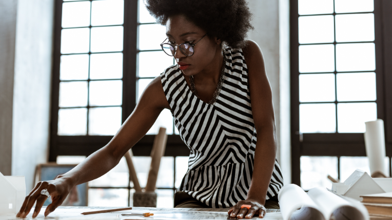 Interior designer wearing striped blouse working hard.