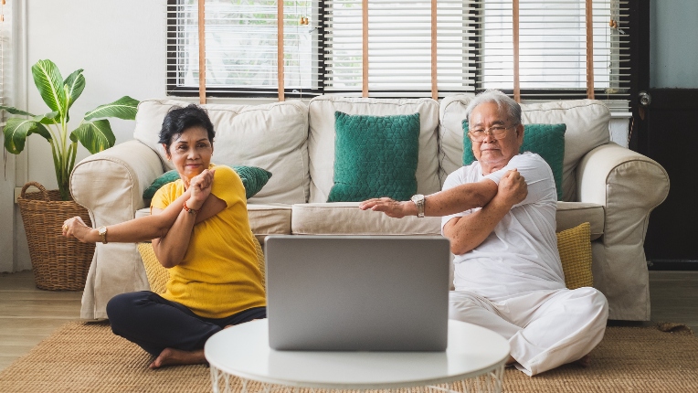Seniors workout exercise and doing yoga at home.