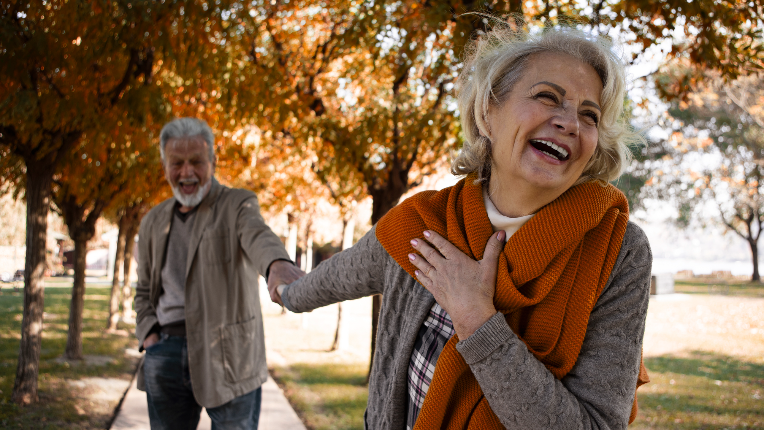 Loving senior couple spending a day in the park holding hands.