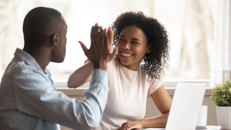 Overjoyed couple give high five celebrating success